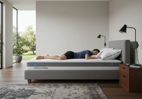 Tall person sleeping comfortably on a long Cal King bed.